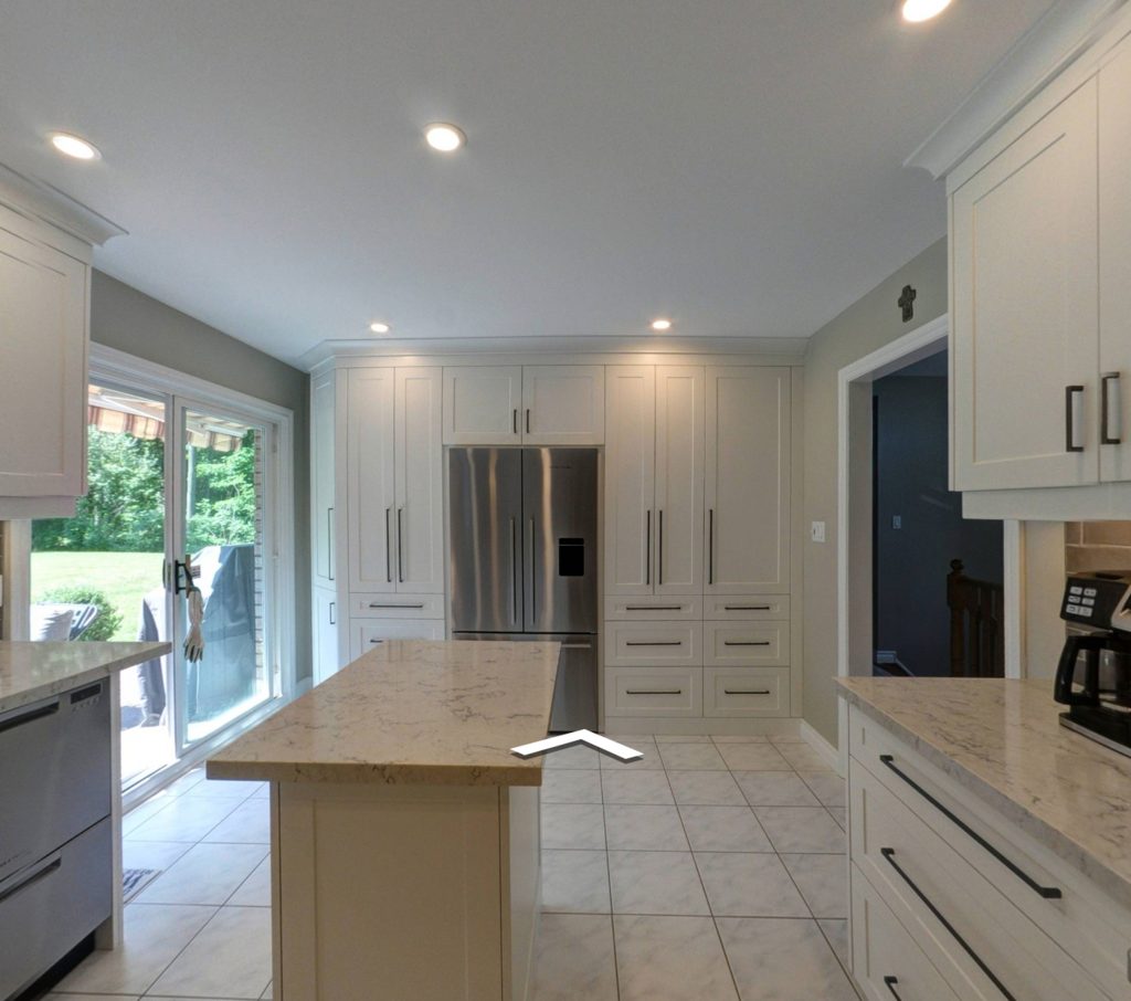 Kitchen renovation, granite countertop, white cabinets with matching kitchen island and white tile flooring