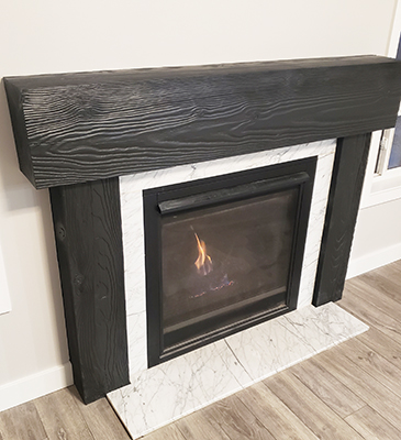 Gas fireplace with black wood frame and marble backsplash